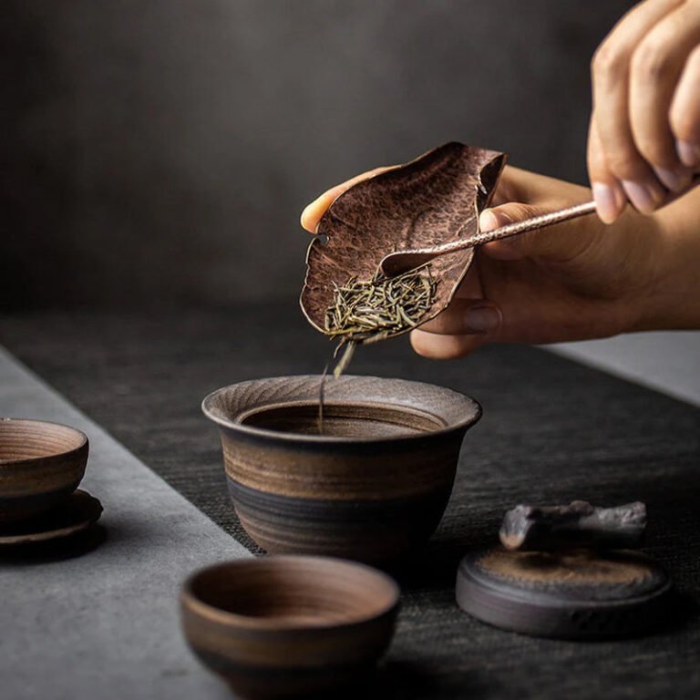 Use a tea scoop to transfer loose tea leaves from the tea spoon into the tea pot.